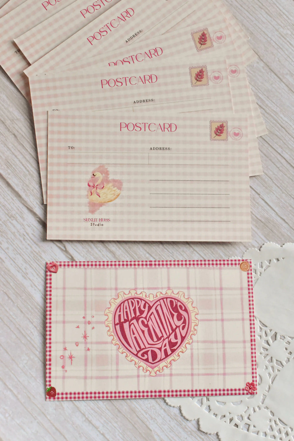 A retro Happy Valentine's Day postcard is styled with pink gingham and swan artwork.