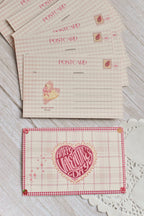 A retro Happy Valentine's Day postcard is styled with pink gingham and swan artwork.