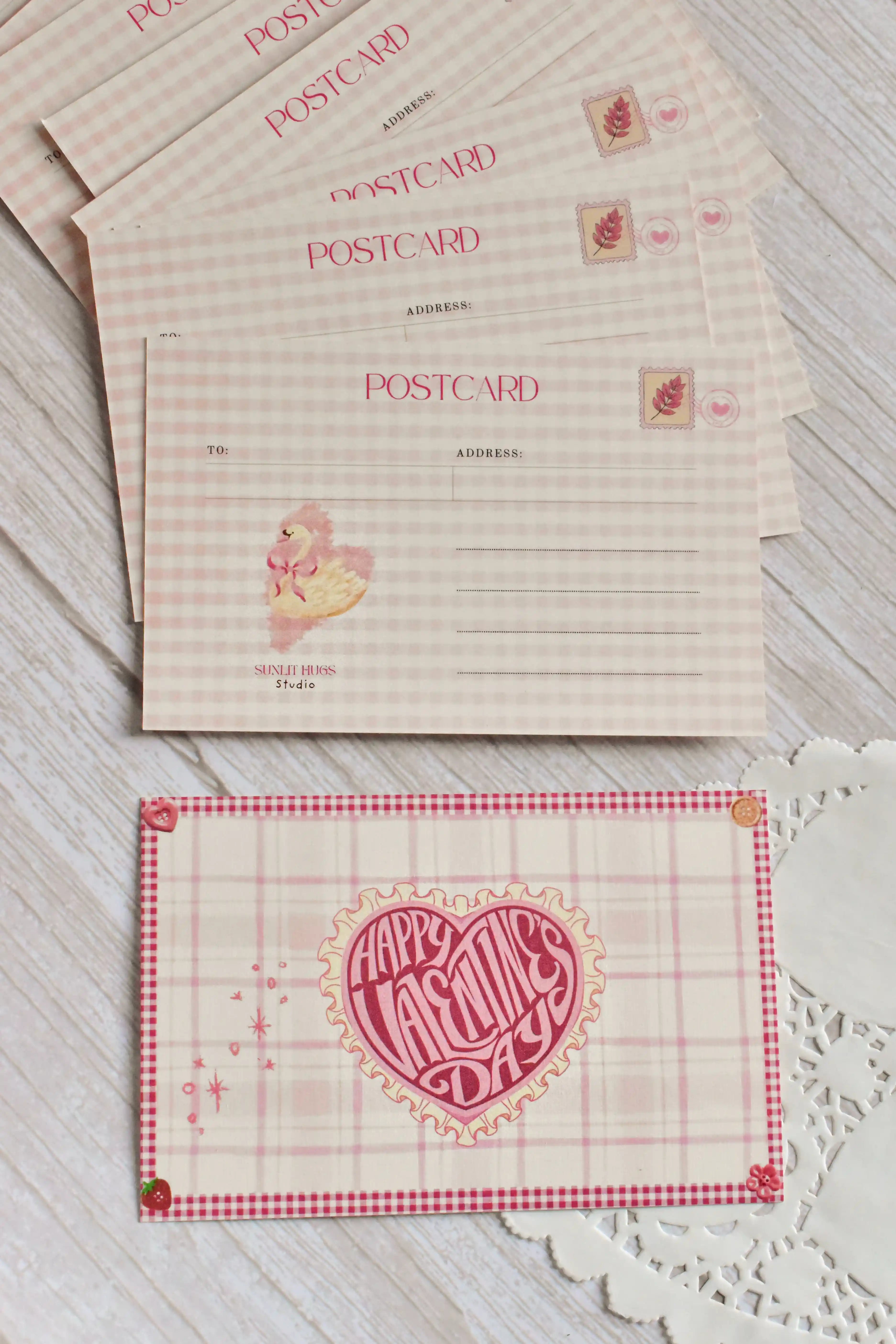 A retro Happy Valentine's Day postcard is styled with pink gingham and swan artwork.