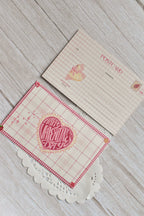 A Happy Valentine's Day postcard is styled in pink gingham with a swan and heart design.