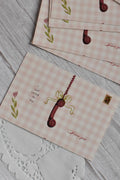 A retro pink gingham postcard reads Just Called to Say I Love You with a vintage telephone illustration.