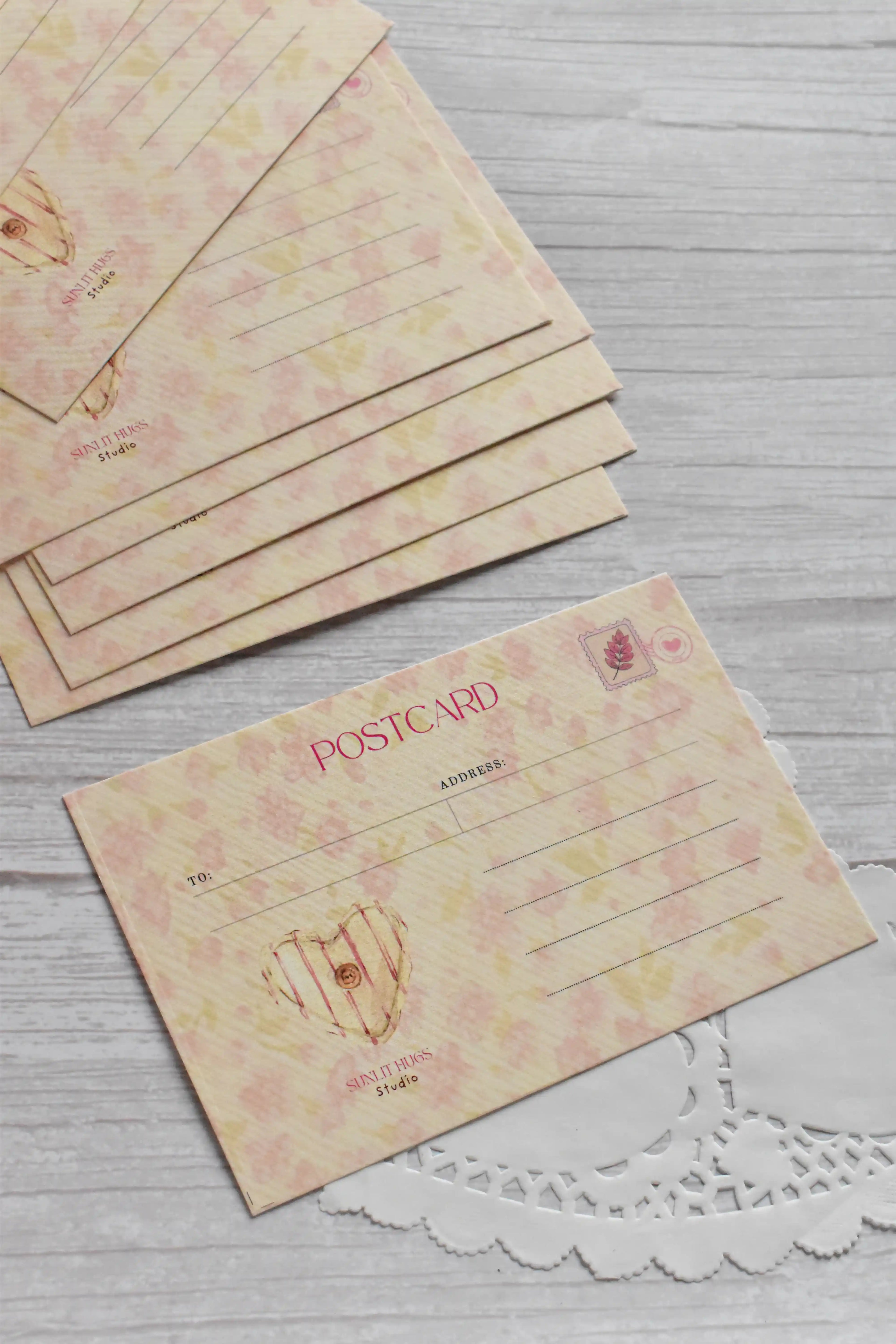 A vintage telephone love postcard is displayed with pink gingham details and romantic retro stationery styling.
