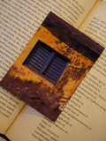 An old window catches soft light, highlighting rustic architectural texture.