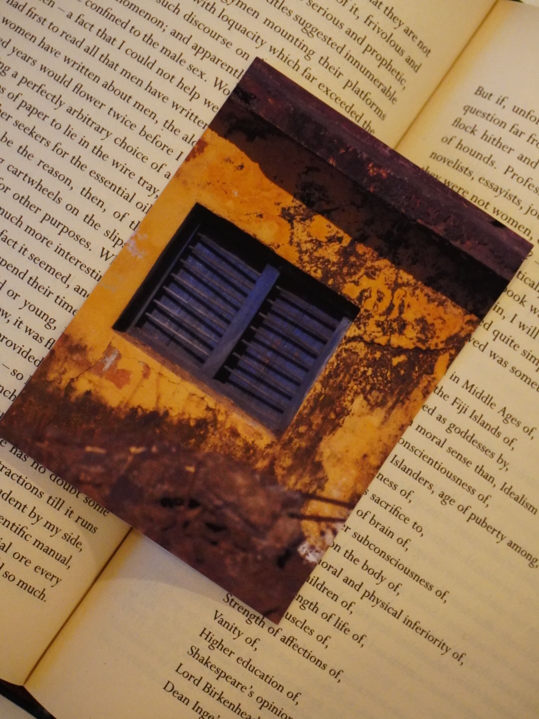 An old window catches soft light, highlighting rustic architectural texture.
