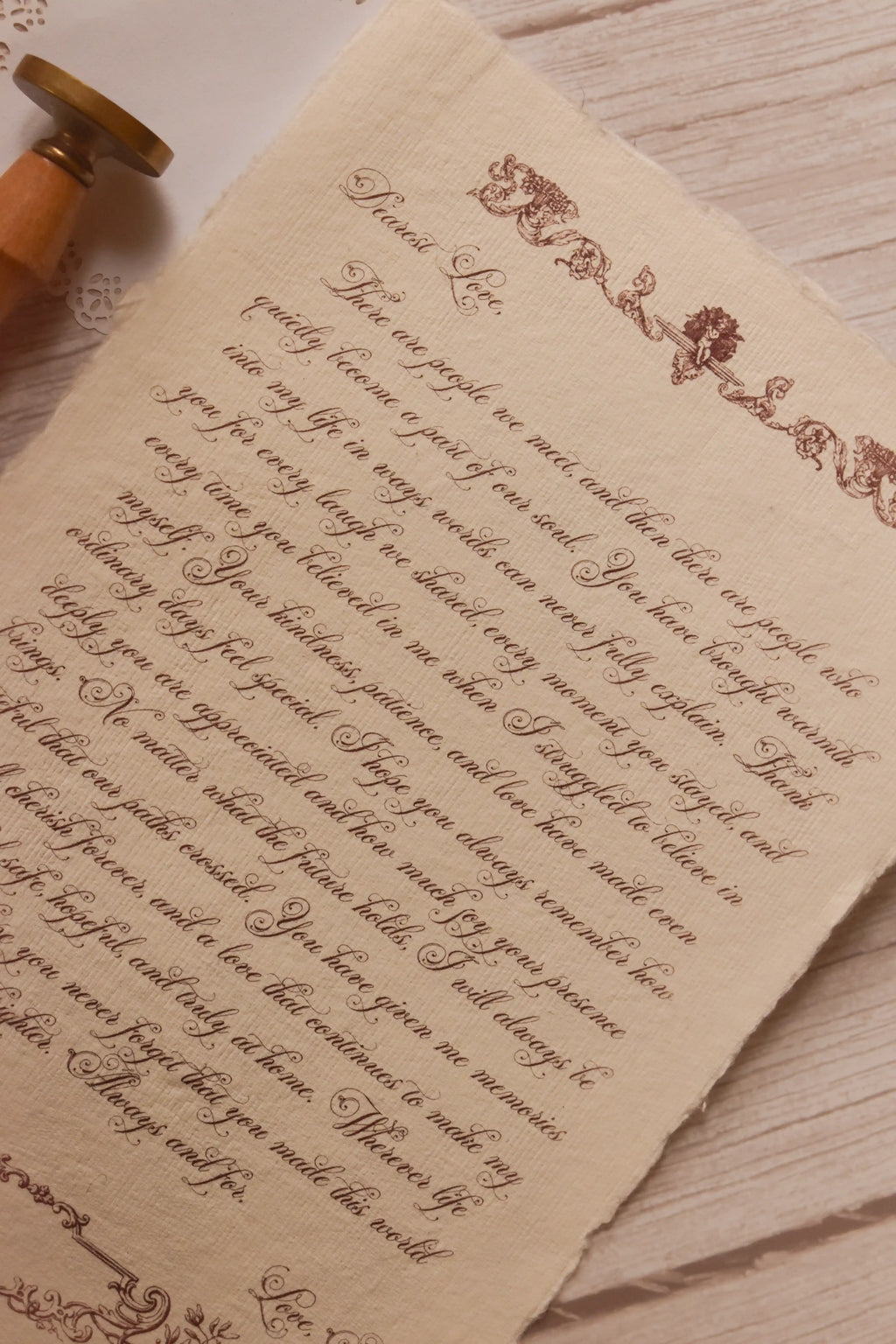 Close-up of the Rosie personalised letter showing its high-quality textured handmade paper, deckled edge, ornate vintage detailing and elegant calligraphy-style message.