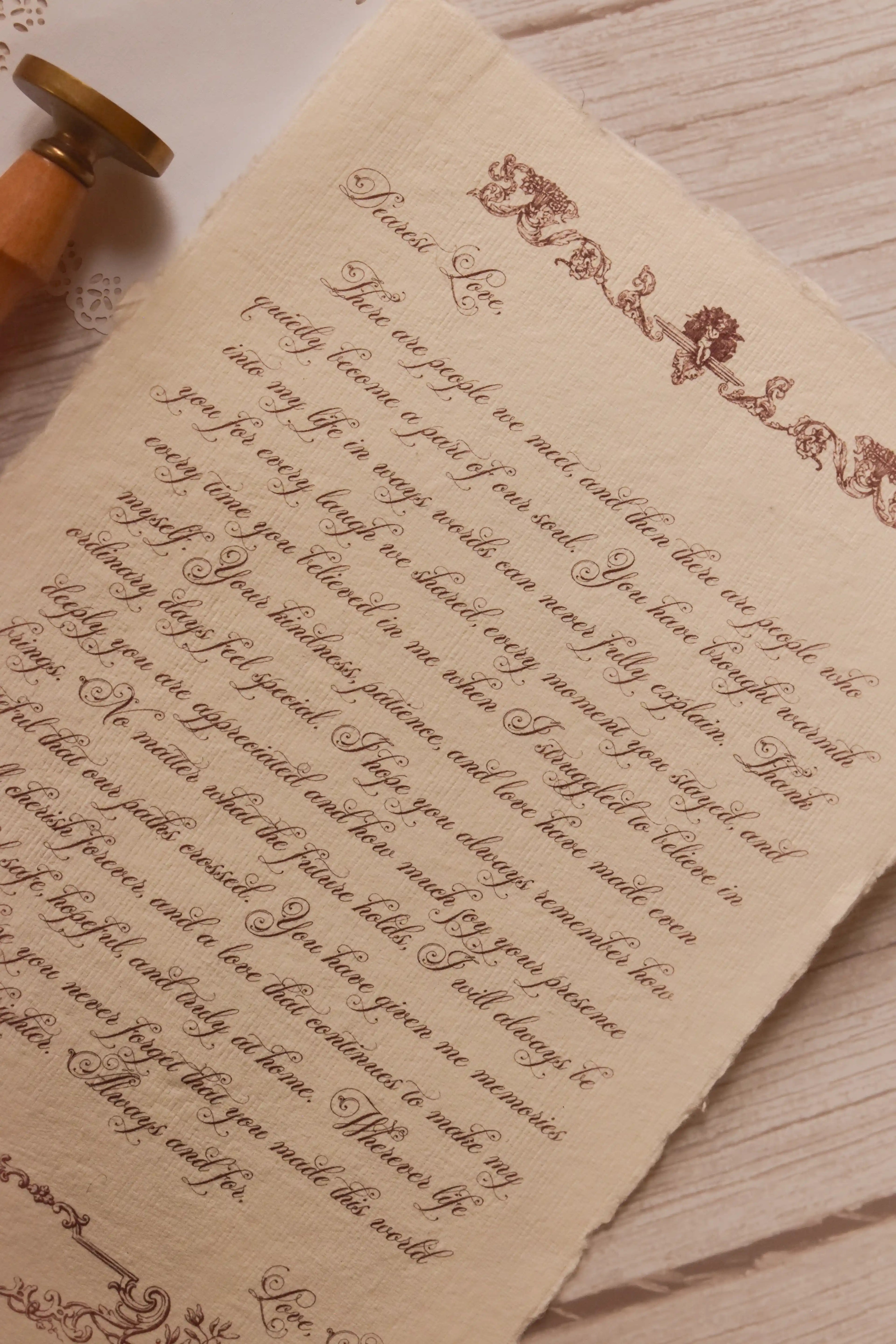 Close-up of the Rosie personalised letter showing its high-quality textured handmade paper, deckled edge, ornate vintage detailing and elegant calligraphy-style message.