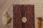 Rosie personalised letter displayed with a deep burgundy floral lace-patterned vellum wrapper, creating a romantic and luxurious vintage stationery presentation.