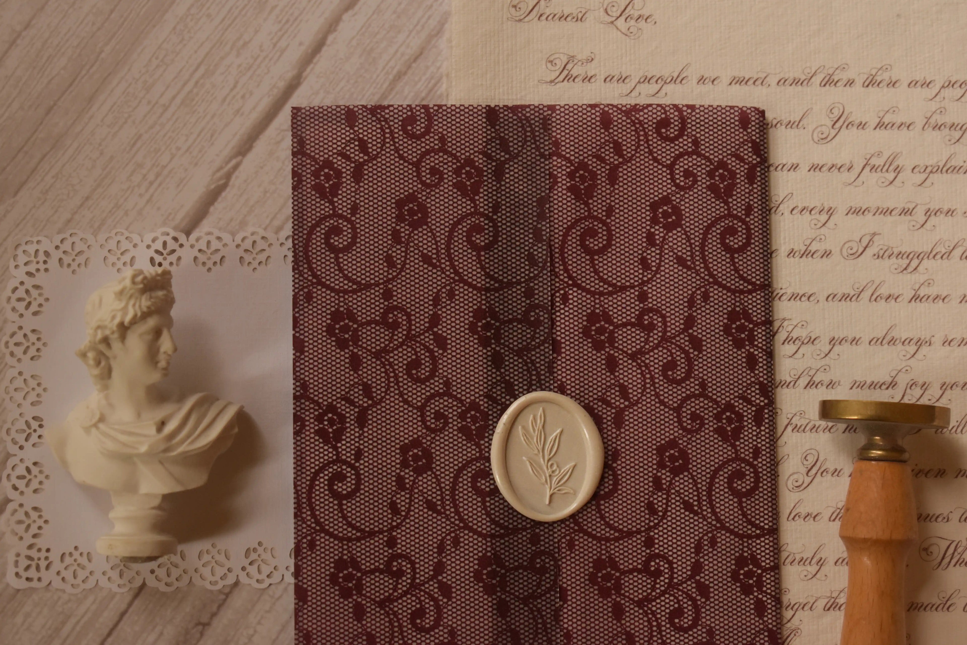 Rosie personalised letter displayed with a deep burgundy floral lace-patterned vellum wrapper, creating a romantic and luxurious vintage stationery presentation.