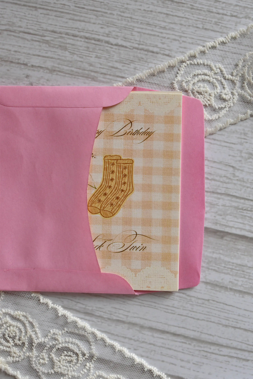 A Sock Twin happy birthday mini card sits partially tucked inside a bright pink envelope.