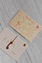 A vintage telephone love postcard is displayed with pink gingham styling and romantic retro lettering.