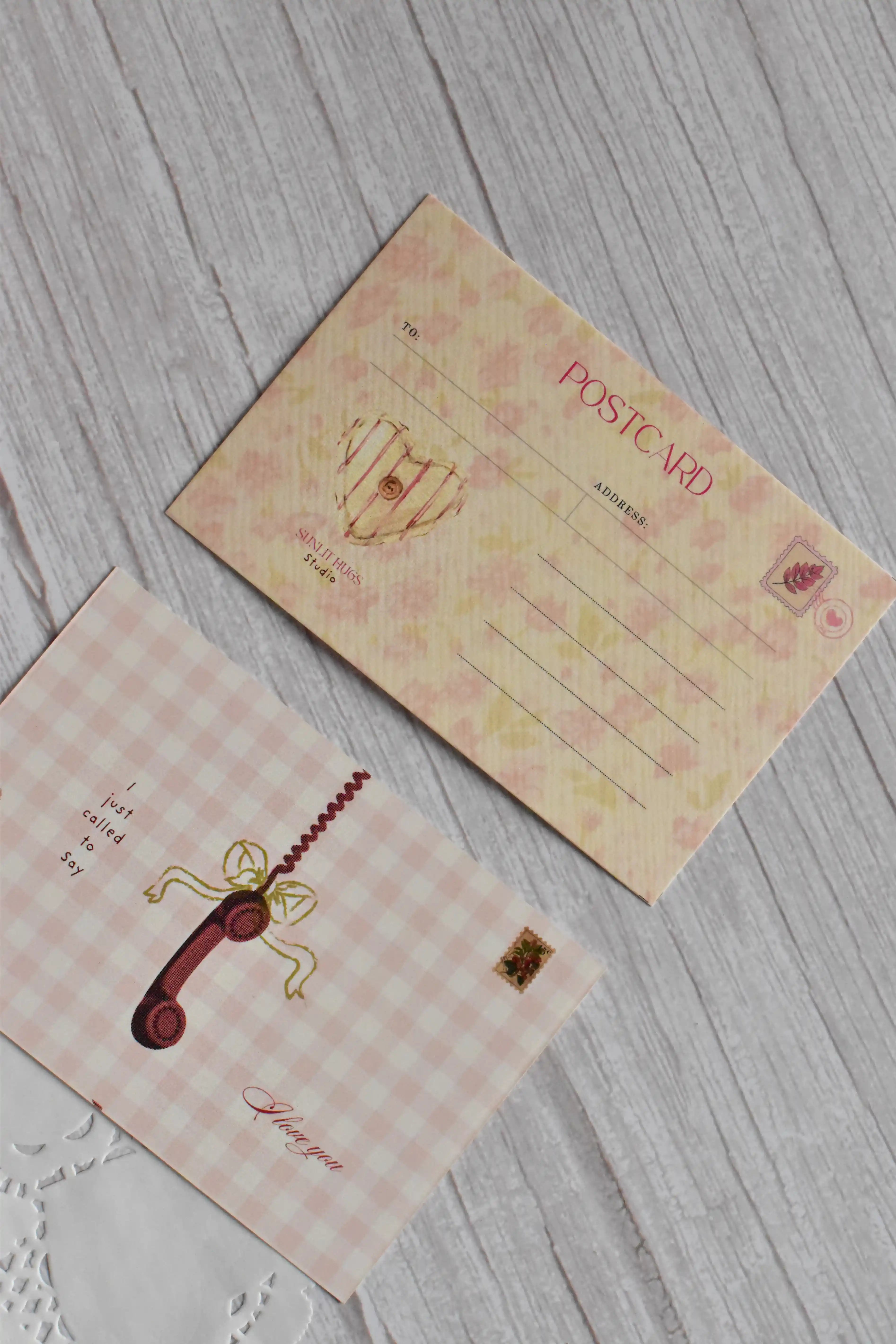 A vintage telephone love postcard is displayed with pink gingham styling and romantic retro lettering.
