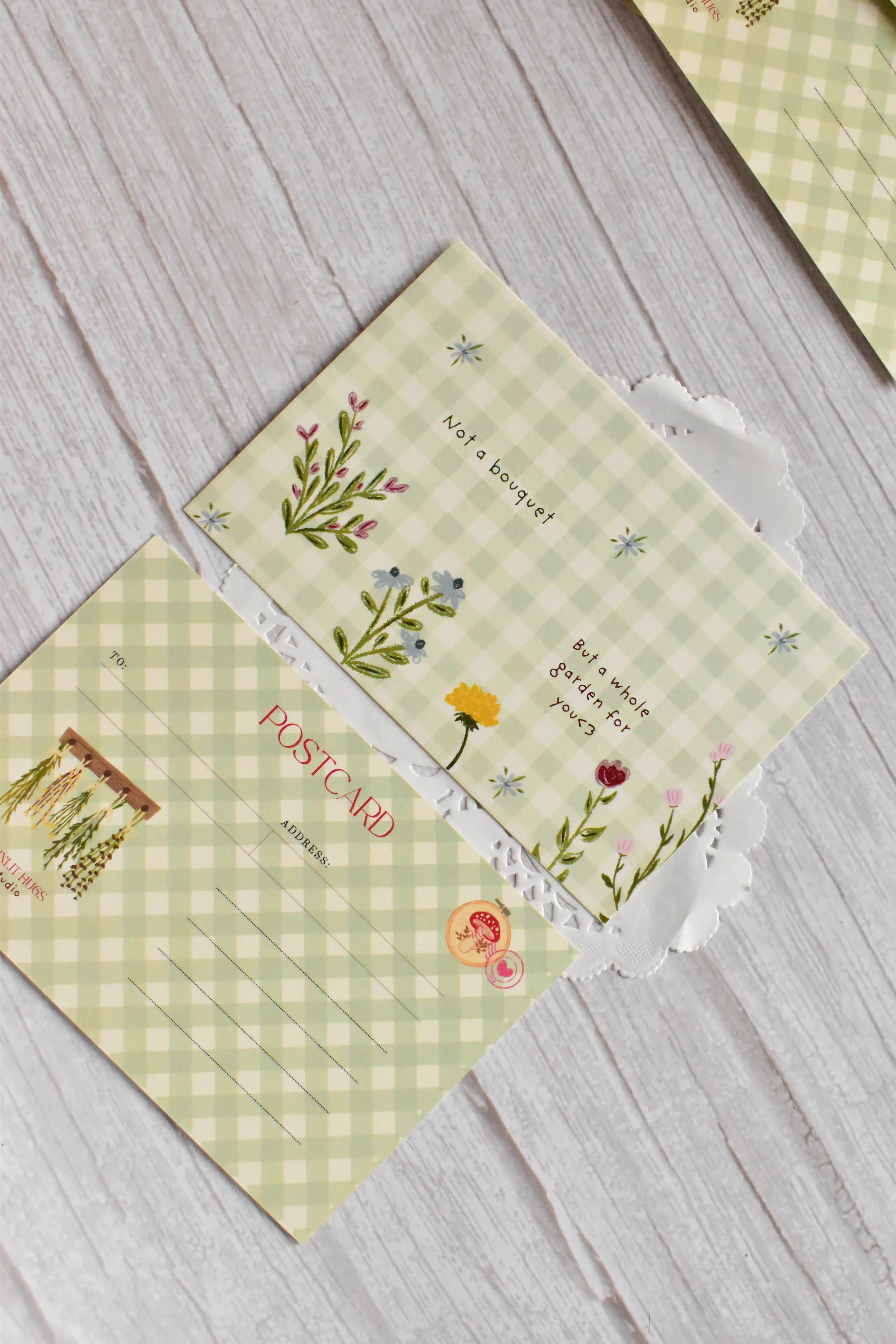 A green gingham garden postcard features cottagecore floral artwork and the phrase Not a Bouquet.