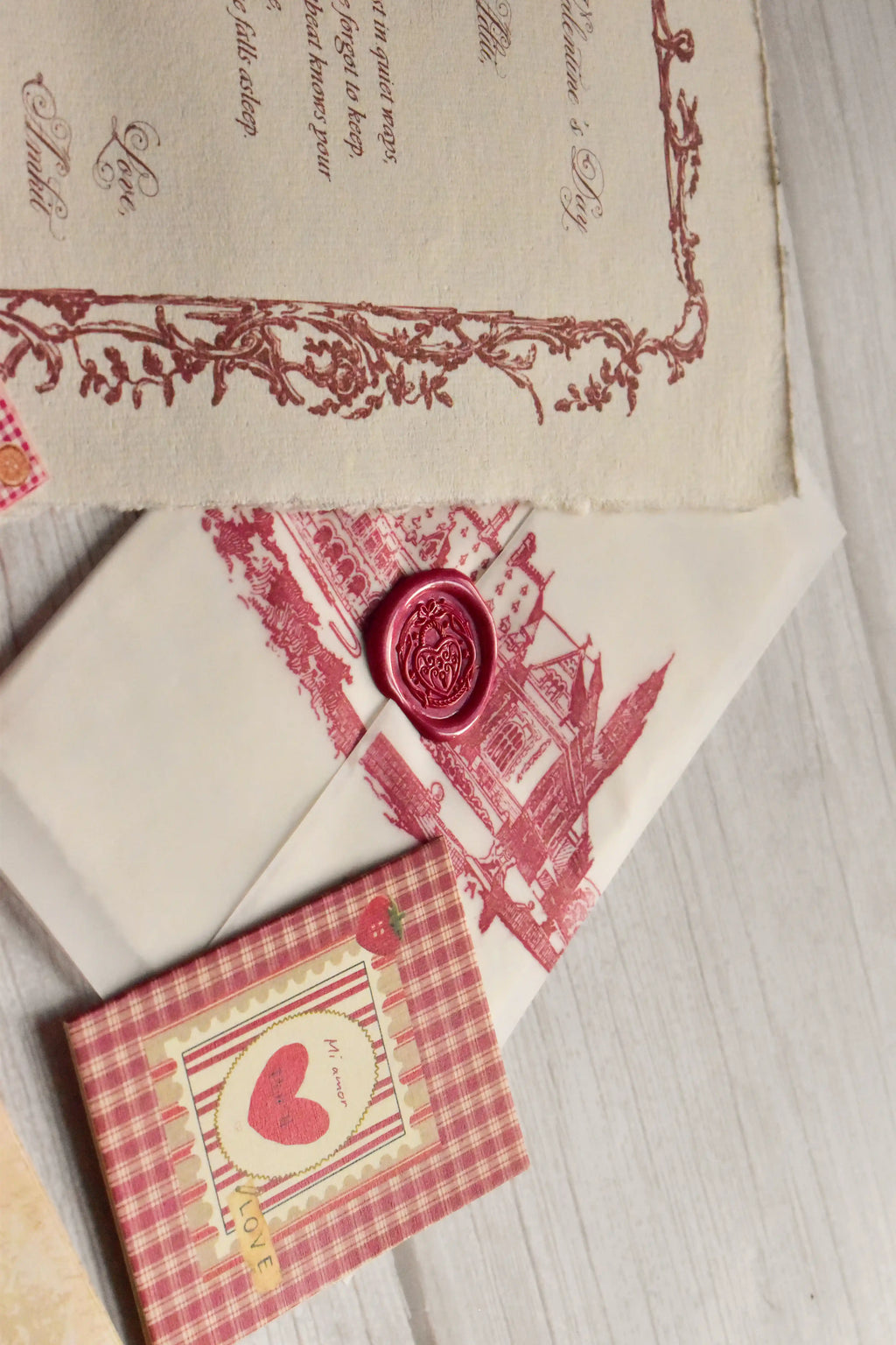 A vintage Valentine's gift bundle is arranged with postcards, mini greeting cards, and a love letter.