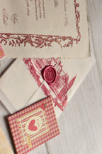 A vintage Valentine's gift bundle is arranged with postcards, mini greeting cards, and a love letter.