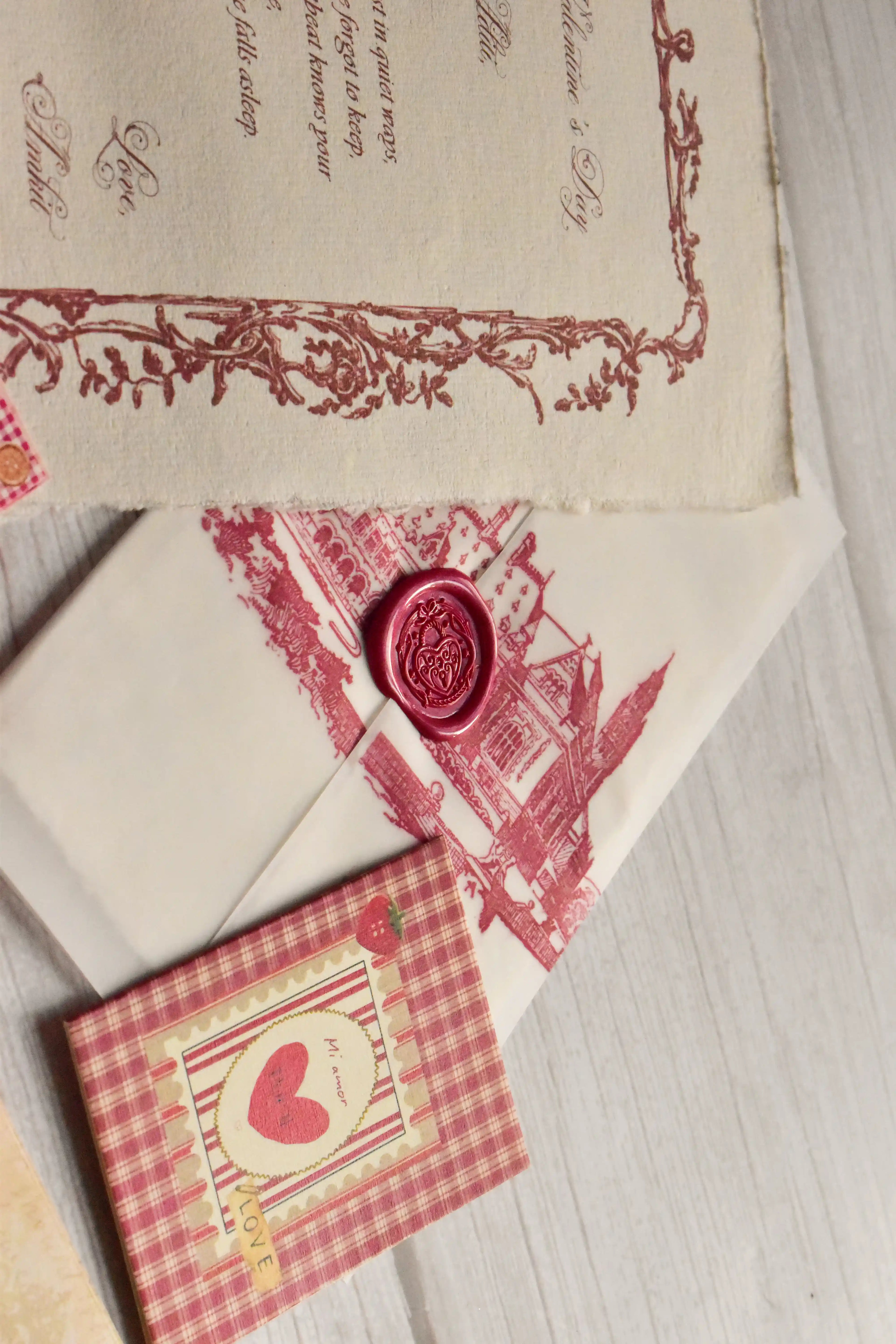 A vintage Valentine's gift bundle is arranged with postcards, mini greeting cards, and a love letter.