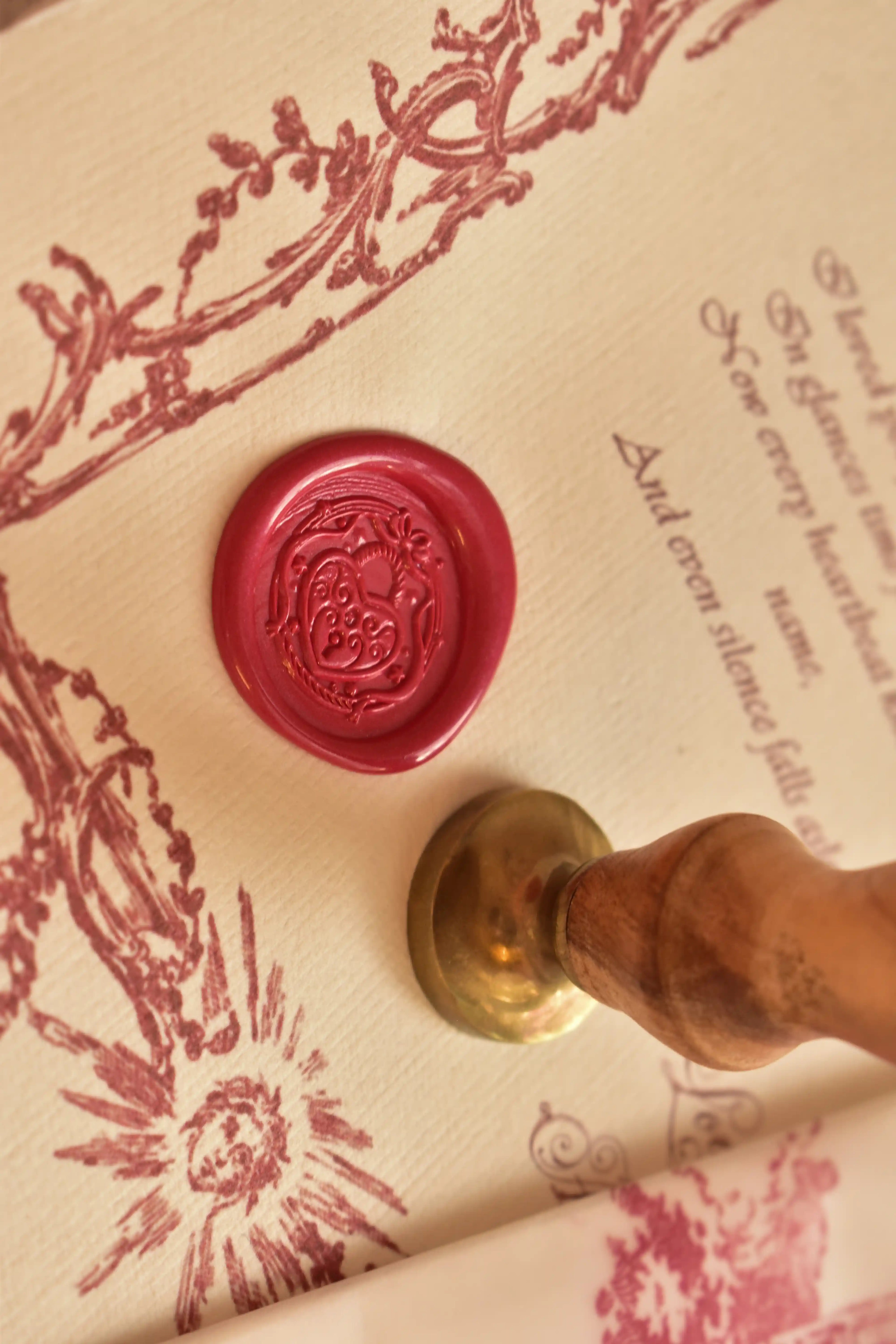 A vintage-style love letter is displayed with a red heart wax seal on soft neutral paper.