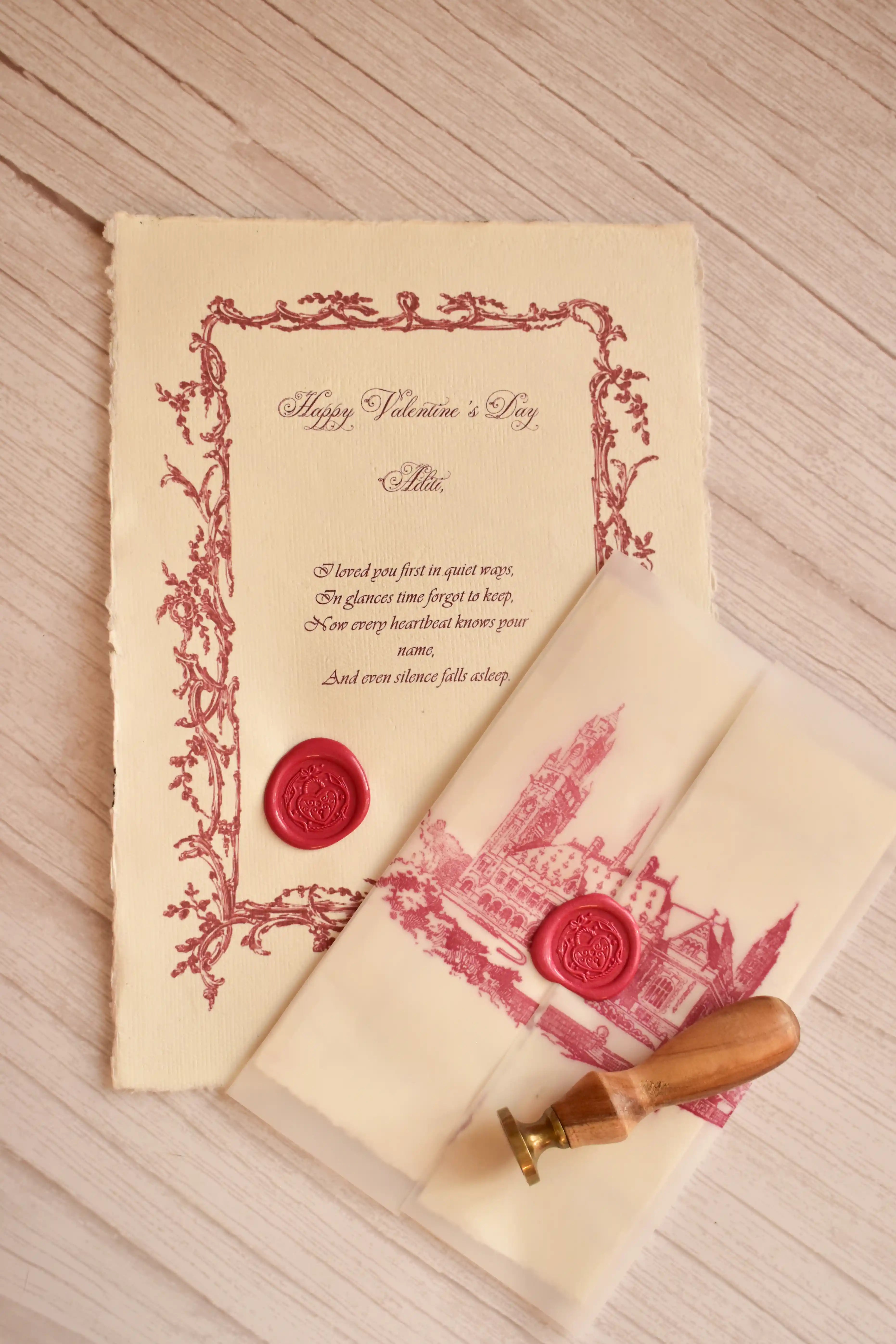 A handcrafted red heart wax seal decorates a vintage-style Valentine letter.