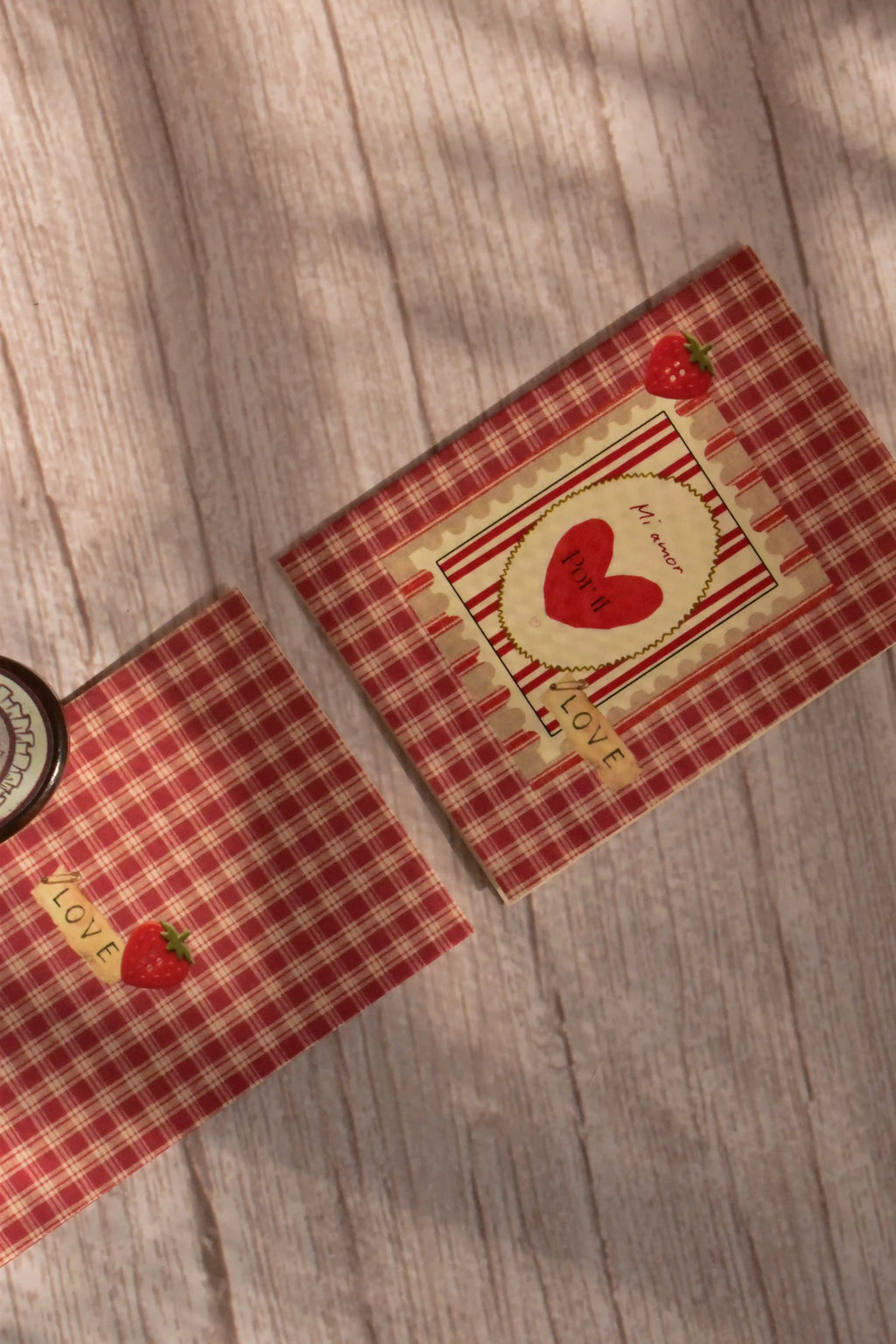 A mini Mi Amor greeting card features red gingham, a strawberry illustration, and a matching pink envelope.