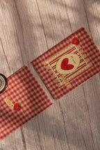 A mini Mi Amor greeting card features red gingham, a strawberry illustration, and a matching pink envelope.