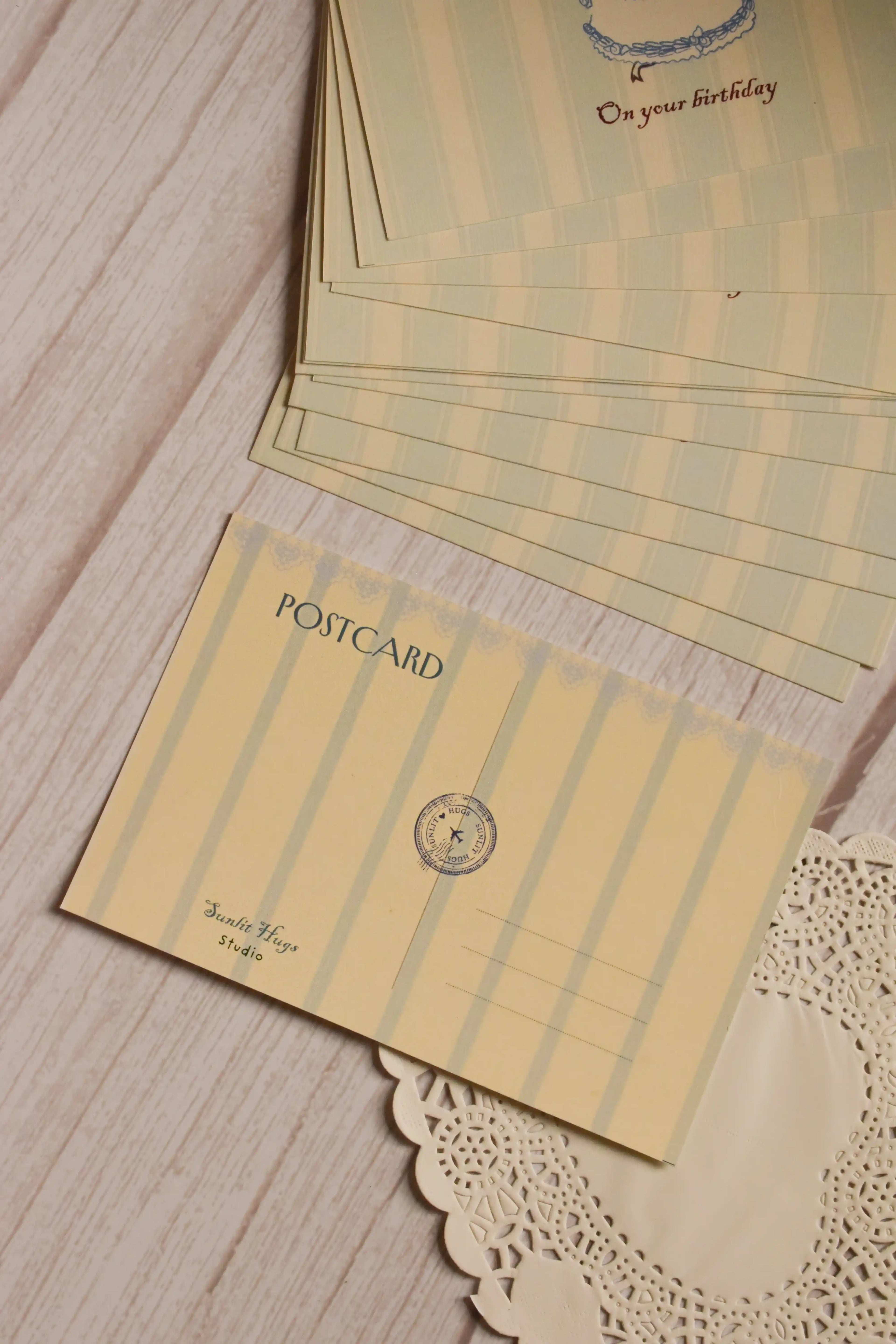 Reverse view of the Star-Wrapped Wishes Birthday Postcard featuring a coordinating striped layout, traditional postcard details and space for writing the recipient’s address and a personal message.