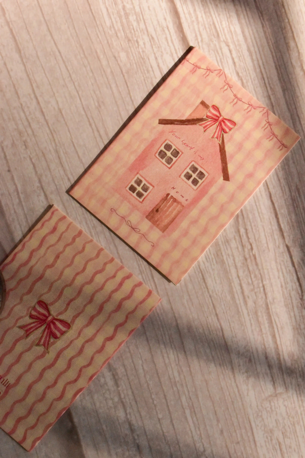 A mini greeting card reads Your Heart is My Home with a pink cottage illustration and bow detail.