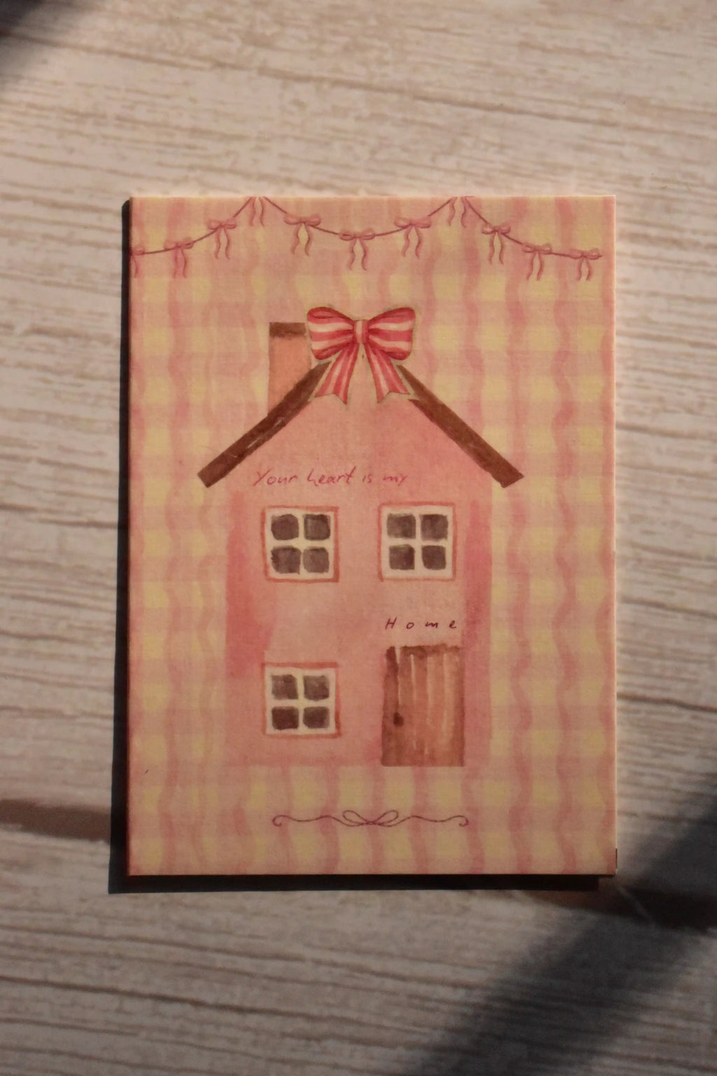 A pink mini greeting card shows a cottage illustration with a bow and the message Your Heart is My Home.