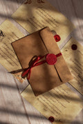 A set of vintage poetry postcards is arranged together in a dark academia-inspired paper flat lay.