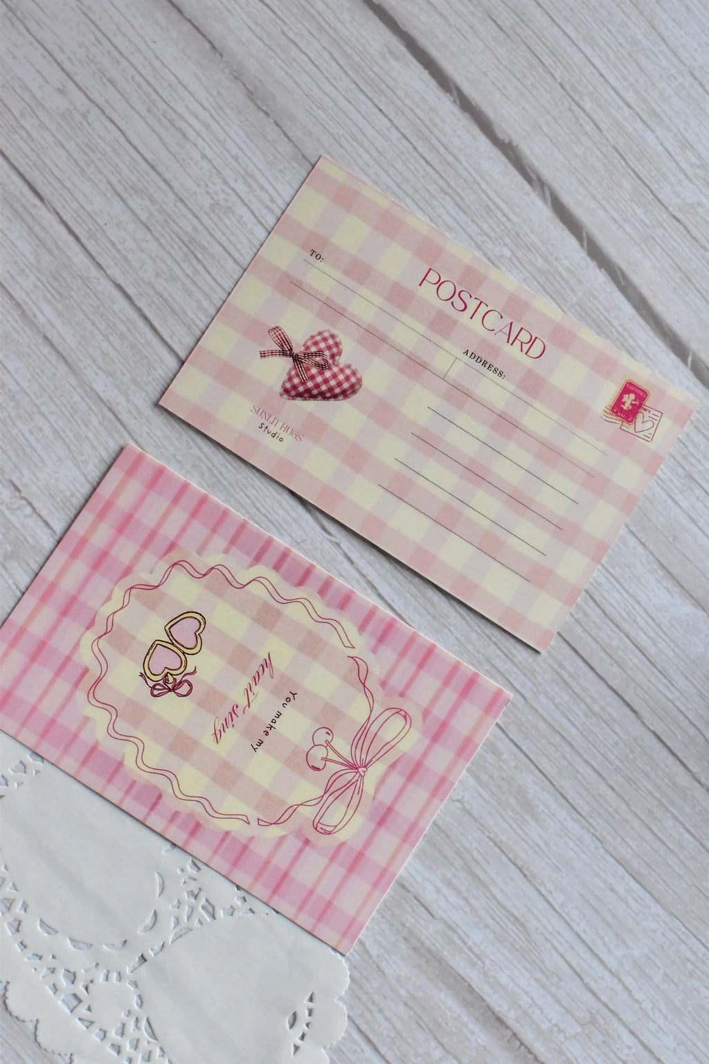 A pink gingham postcard reads You Make My Heart Sing with retro cherries and bow illustrations.