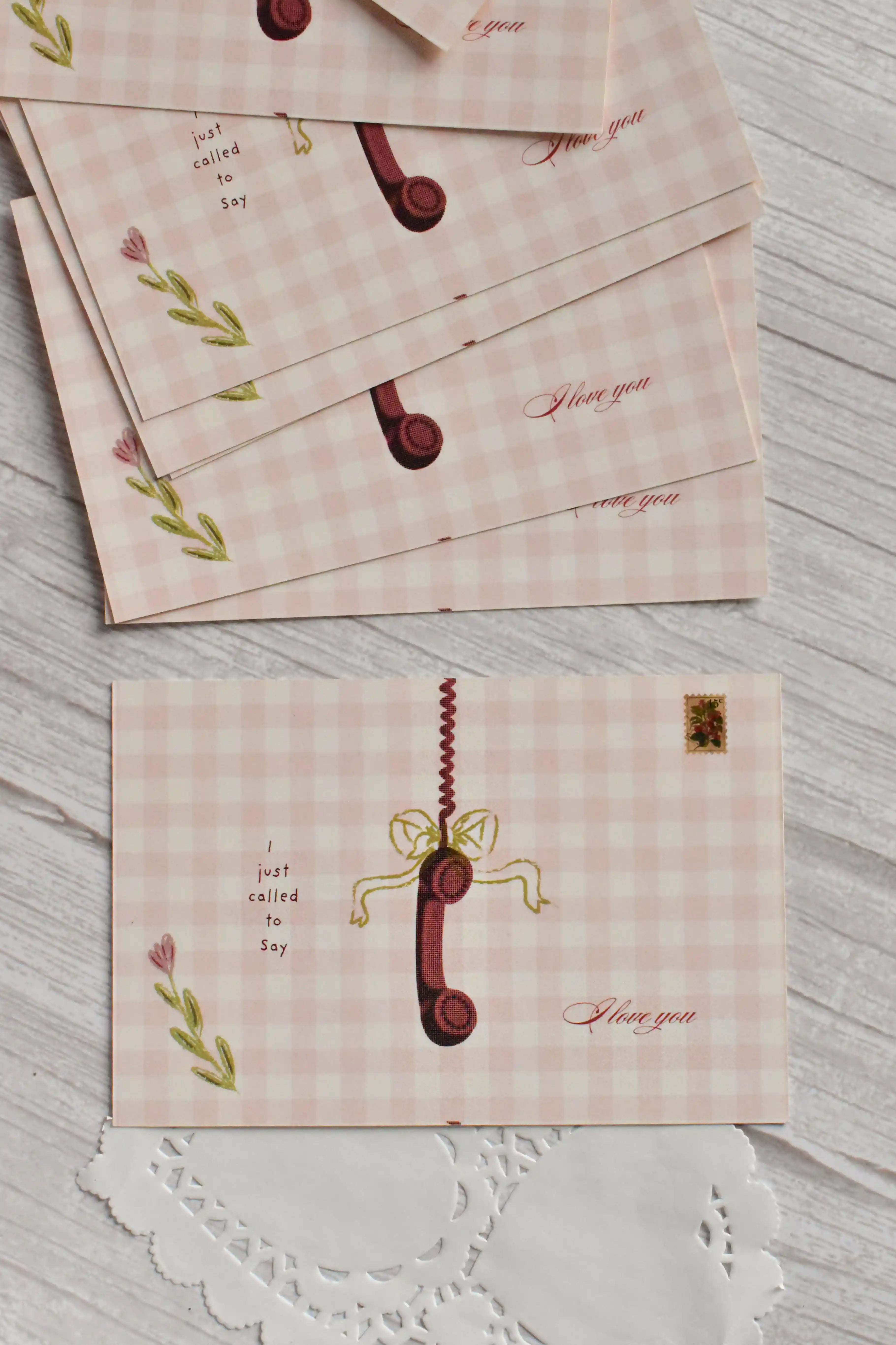 A vintage telephone Valentine postcard features the message Just called to say I love you.