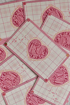 A pink gingham Valentine postcard features a retro heart and swan design.