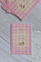 A pink gingham postcard shows retro cherries, bows, and the message You Make My Heart Sing.